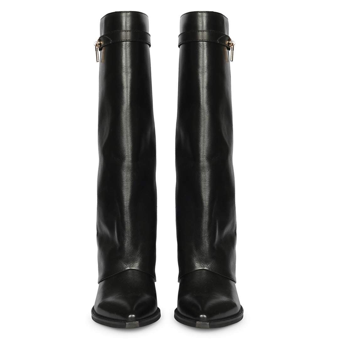 A pair of black leather knee-high boots with pointed toes and a decorative strap detail
