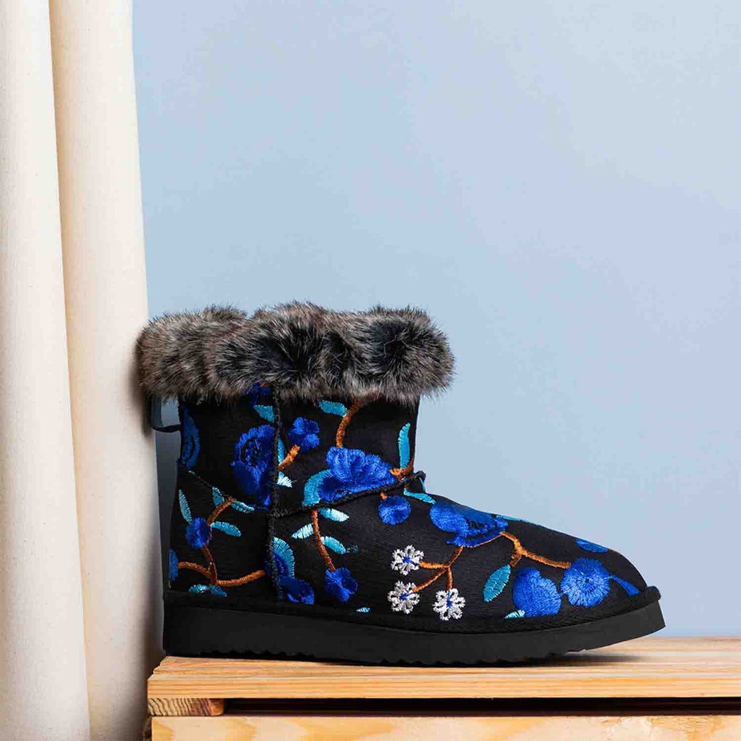 Suede leather snug boots with vibrant blue floral embroidery by Saint Clarisse