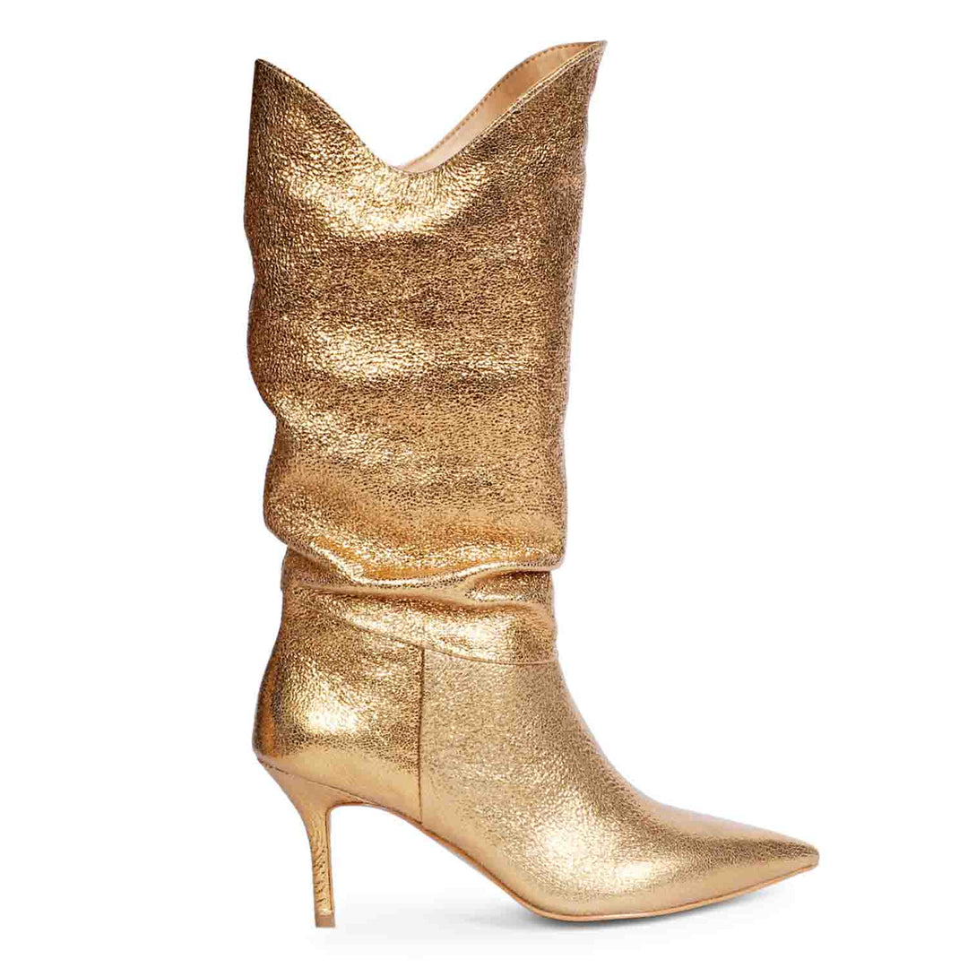 Versatile and glamorous, Saint Nayeli's gold metallic slouch boots for any outfit.