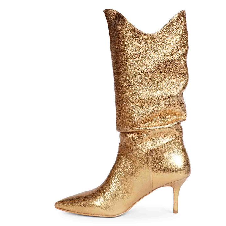 Versatile and glamorous, Saint Nayeli's gold metallic slouch boots for any outfit.