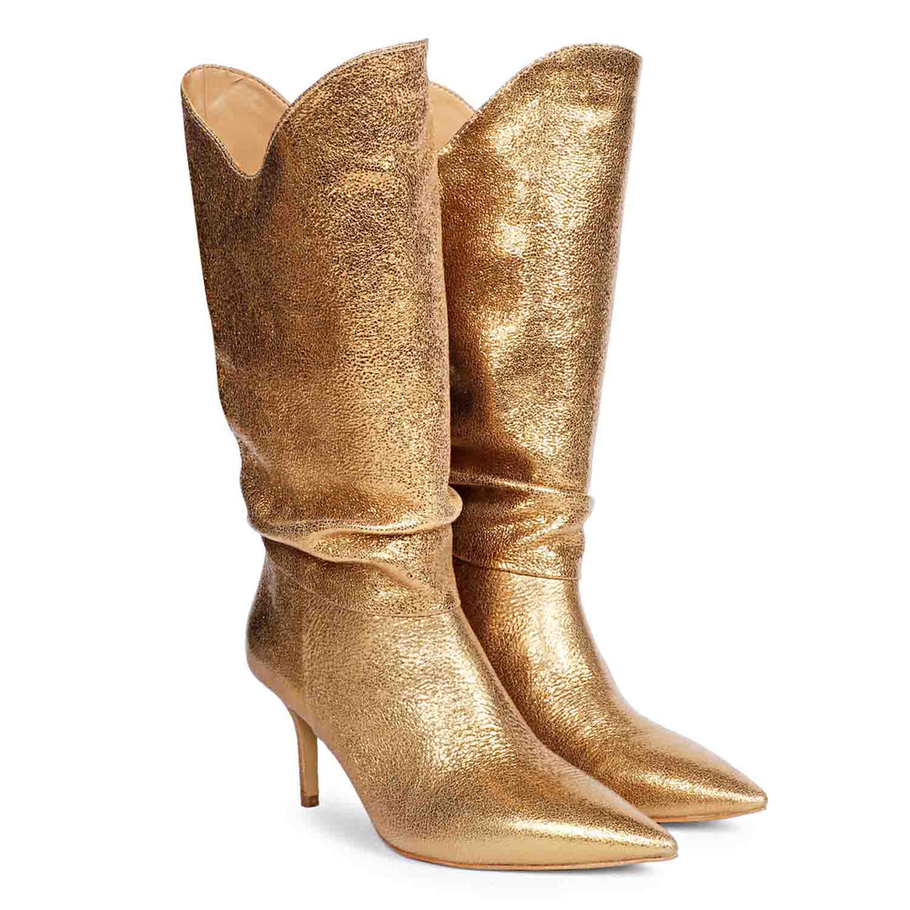 Versatile and glamorous, Saint Nayeli's gold metallic slouch boots for any outfit.