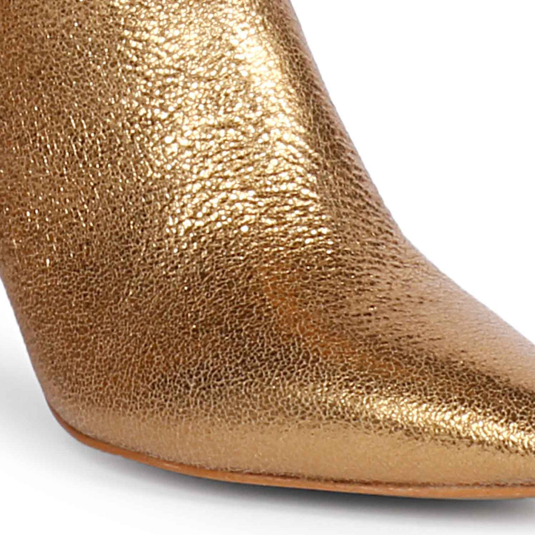 Versatile and glamorous, Saint Nayeli's gold metallic slouch boots for any outfit.